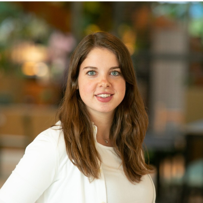 Beau, one of the designers who raises research requests. A headshot, smiling, against a blurred office background.